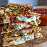 Golden mini quesadilla triangles filled with melted cheese and colorful bell peppers, served with a zesty tomato salsa for a fun, kid-friendly lunch.