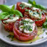 Vibrant Caprese Salad with Basil Oil Drizzle: Colorful layers of ripe tomatoes, creamy mozzarella, and fresh basil, finished with a homemade basil oil infusion.