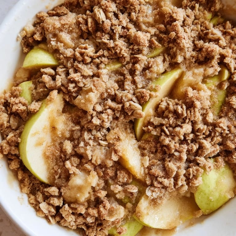 A close-up of a freshly baked Apple Crumble, showing buttery crumble and tender apples.